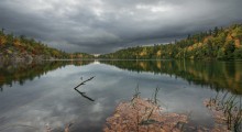 Pink Lake / Pink Lake is a meromictic lake located in Gatineau Park, Quebec, Canada. During the summer, the surface of the waters are a deep green due to the abundance of algae in the water. The lake is in danger of eutrophication due to human activities. Park management forbids swimming in the lake, walking domestic animals near it, straying from the wooden boardwalk for sight-seers, and throwing stones into the lake.