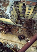 With a boom crane. / ***