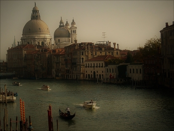 Classical Venice / The Grand Canal is the largest and most famous waterway in Venice. It serves as a vital transportation route, forming a major corridor for water traffic in the city. The canal stretches approximately 3.8 kilometers in length and varies in width from 30 to 90 meters.
The canal is lined with stunning architecture, including palaces, churches, and public buildings that showcase various styles such as Romanesque and Gothic.
Santa Maria della Salute, shown here, is a prominent Roman Catholic church and minor basilica located at the Punta della Dogana in the Dorsoduro sestiere of Venice. It is one of the most recognisable landmarks in Venice, famous for its striking dome that can be seen from various points throughout the city.
Photo by Michel Guntern, https://TravelNotes.org
