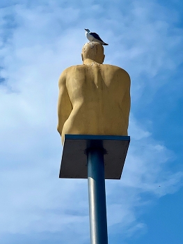 In the style of Magritte / One of seven statues of kneeling men representing the seven continents known as Conversation in Nice, France