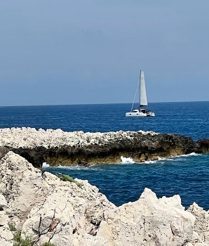 A lonely sailboat / Sailboat in the sea