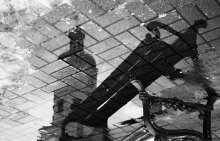 Shop and the town hall, reflected in a puddle on the central square of Niasvizh / ...............