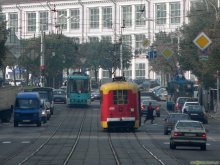 red tram on the street red / ***