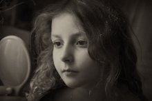 Girl looking in a mirror. / ***