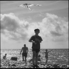 As a little boy enjoys the launch of a volatile snake. / ***