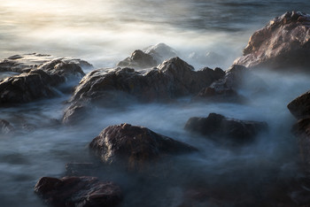 Cliffs / One windy evening by the ocean with the sun setting and waves crashing around the rocks