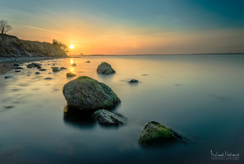 Sonnenuntergang am Brodtener Ufer / Kurz bevor die Sonne am Horizont hinter dem Timmendorfer Strand versinkt, taucht sie noch einmal das Brodtener Ufer in ein abendliches Licht.